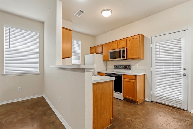 kitchen featuring kitchen peninsula, plenty of natural light, and white appliances