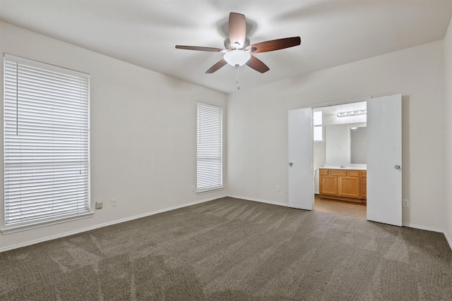 unfurnished bedroom featuring carpet, ceiling fan, and ensuite bathroom