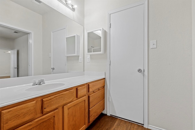 bathroom with hardwood / wood-style floors and vanity