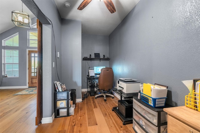 office area featuring light wood-style floors, ceiling fan, baseboards, and a textured wall