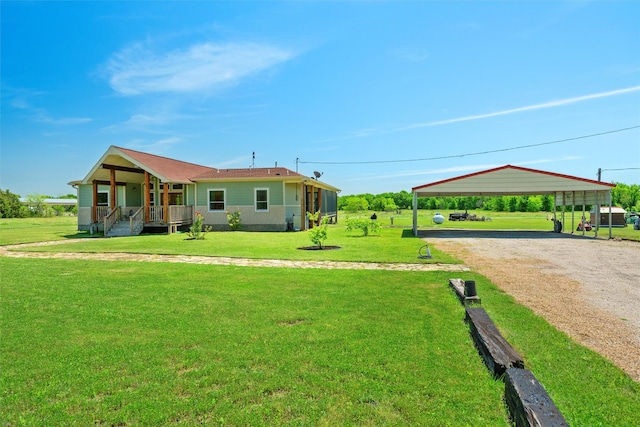 view of front of property featuring covered porch, dirt driveway, a carport, and a front yard