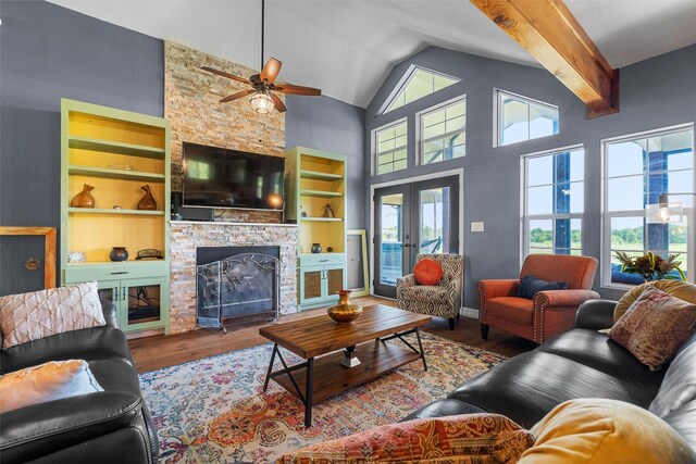 living room featuring light hardwood / wood-style flooring, ceiling fan, and vaulted ceiling with beams