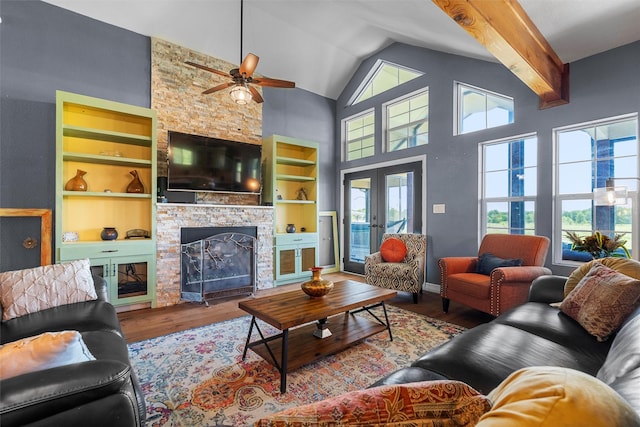 living room with high vaulted ceiling, built in shelves, a fireplace, wood finished floors, and french doors