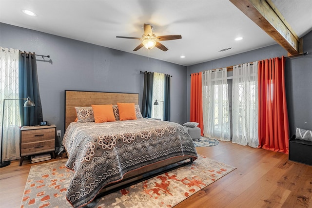 bedroom featuring recessed lighting, beam ceiling, visible vents, and wood finished floors