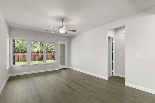 spare room with ceiling fan and dark wood-type flooring