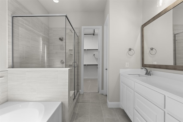 bathroom featuring independent shower and bath, vanity, and tile patterned flooring