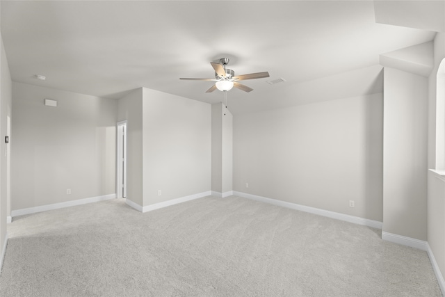 spare room featuring ceiling fan and light colored carpet