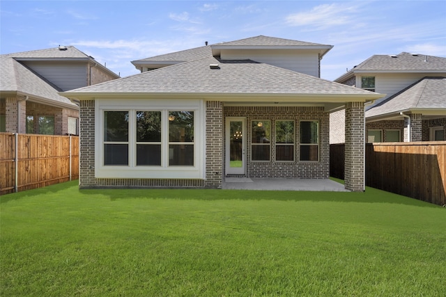 back of property featuring a lawn and a patio