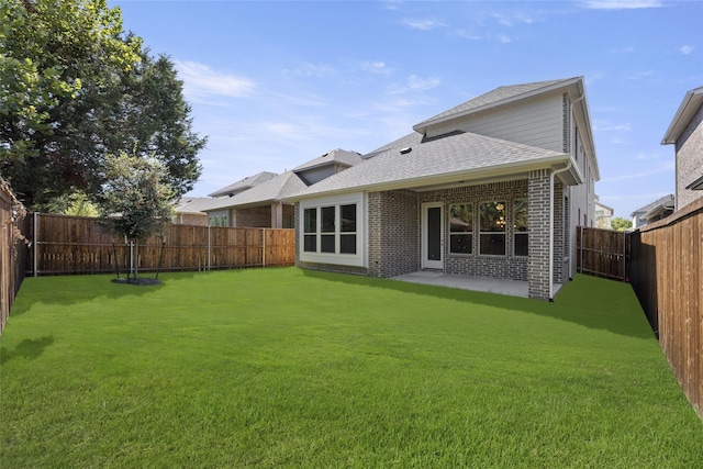 rear view of house featuring a patio area and a yard