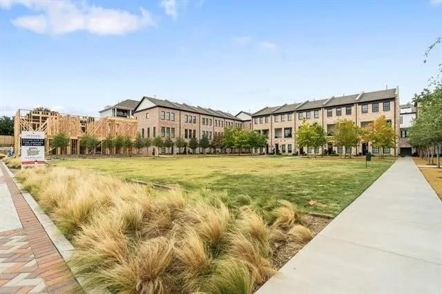 view of property's community with a lawn