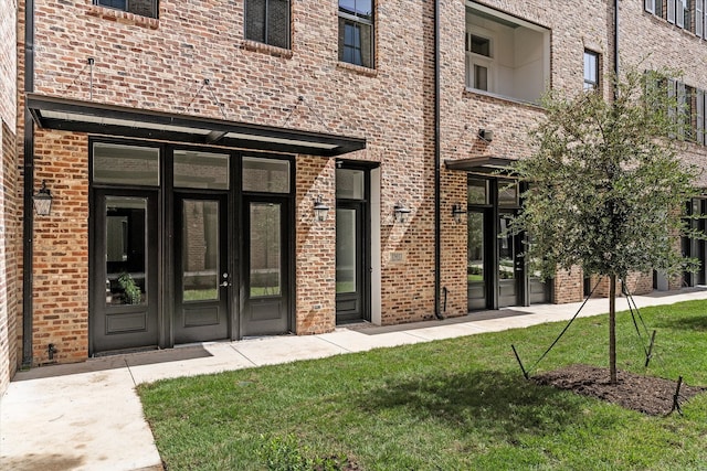 property entrance featuring french doors and a lawn