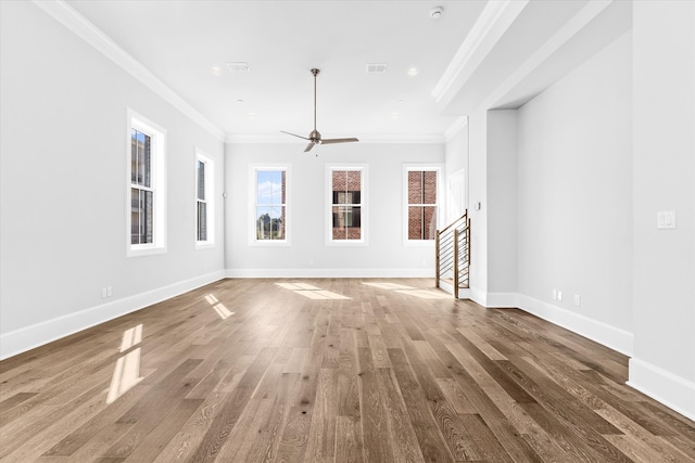 unfurnished living room featuring ornamental molding, wood-type flooring, and ceiling fan