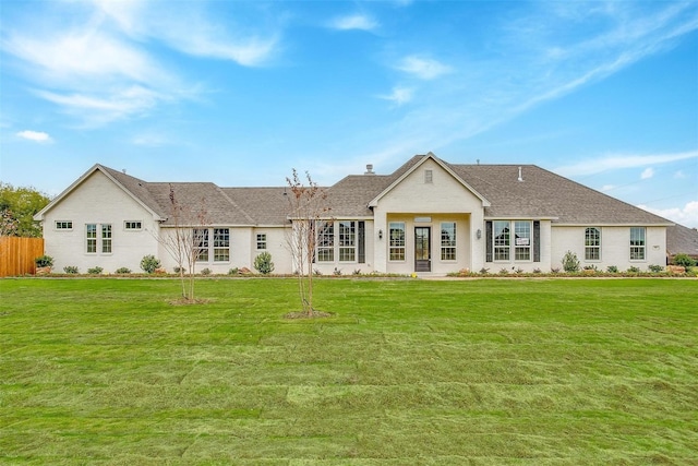 rear view of house with a yard