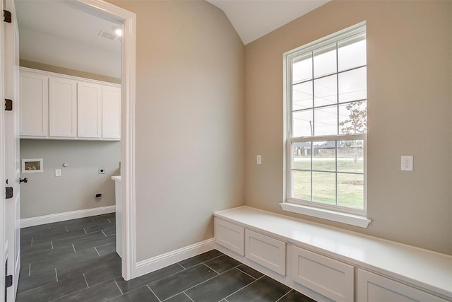 mudroom with vaulted ceiling and dark tile floors