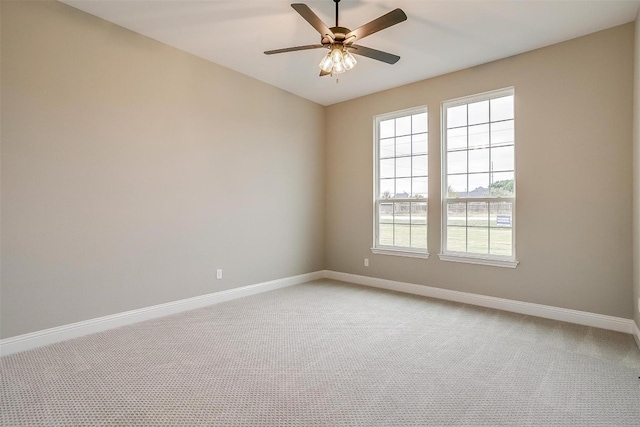 unfurnished room with light colored carpet and ceiling fan