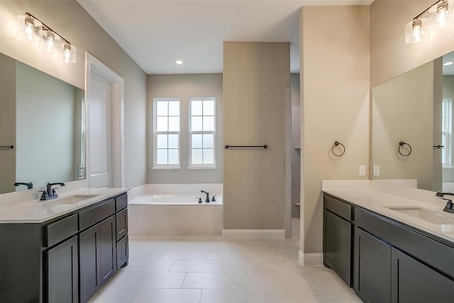 bathroom with vanity, tile floors, and a bathtub