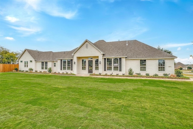 back of house with a lawn