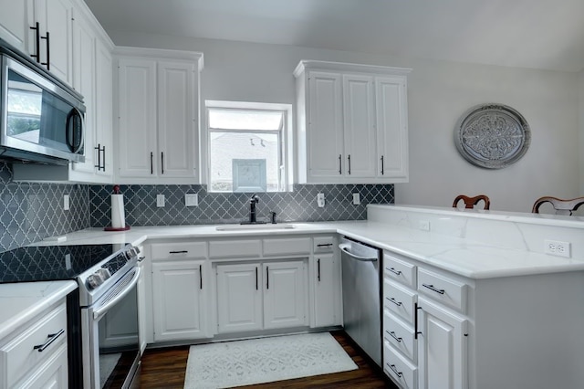 kitchen with white cabinets, sink, dark hardwood / wood-style flooring, and stainless steel appliances