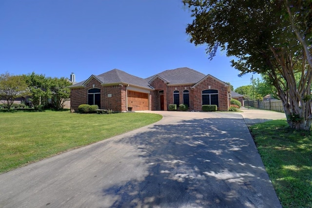 ranch-style house featuring a front lawn and a garage