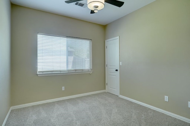 carpeted empty room featuring ceiling fan