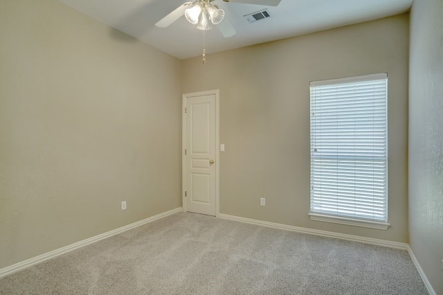 empty room featuring light colored carpet and ceiling fan