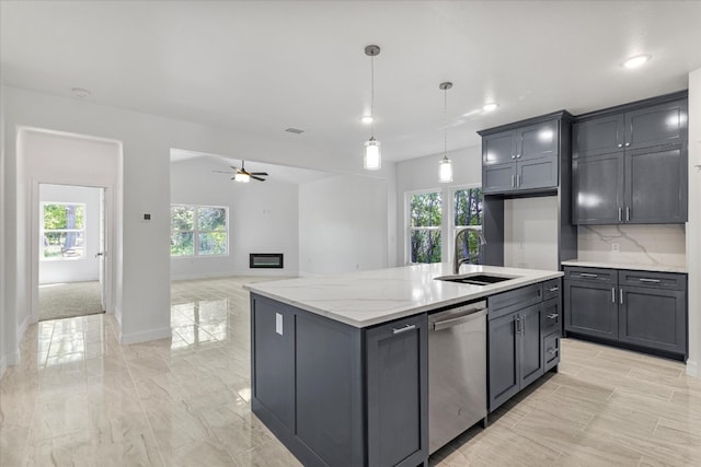 kitchen with light stone countertops, sink, hanging light fixtures, a center island with sink, and dishwasher