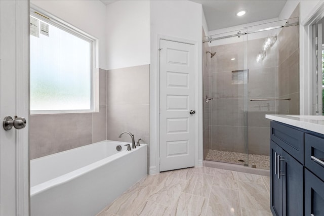 bathroom featuring independent shower and bath and vanity