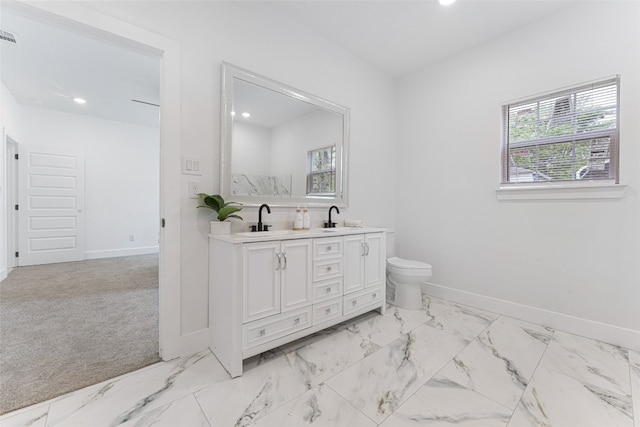 bathroom featuring toilet, tile floors, and double sink vanity