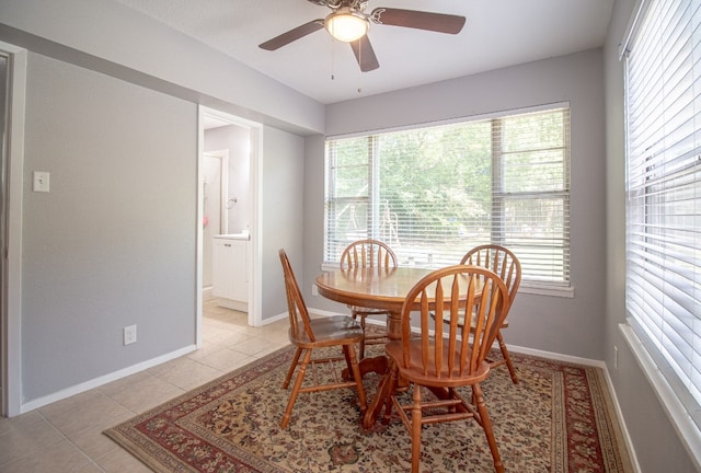 tiled dining area with ceiling fan