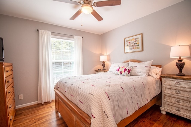 bedroom with ceiling fan and dark hardwood / wood-style floors