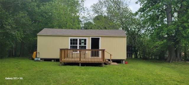 back of house featuring a yard and a wooden deck