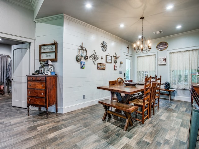 dining space featuring a notable chandelier, crown molding, and dark hardwood / wood-style floors