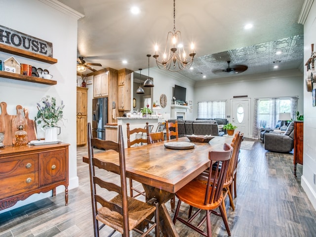 dining space with ceiling fan with notable chandelier, dark hardwood / wood-style floors, crown molding, and a textured ceiling