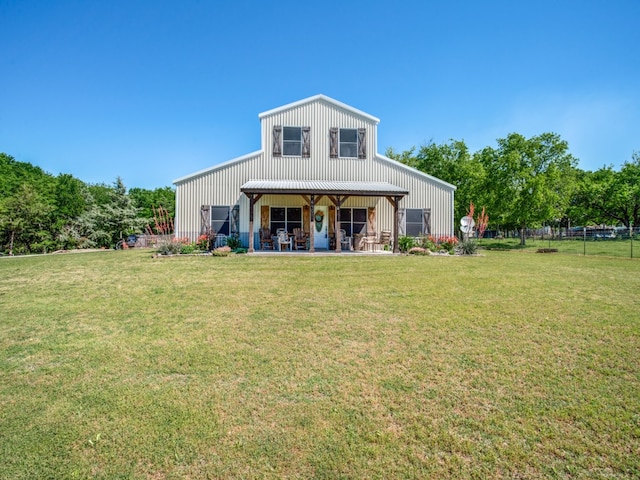 rear view of property with a yard