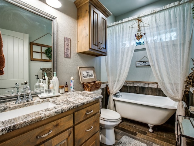 bathroom with vanity, toilet, and a bathtub