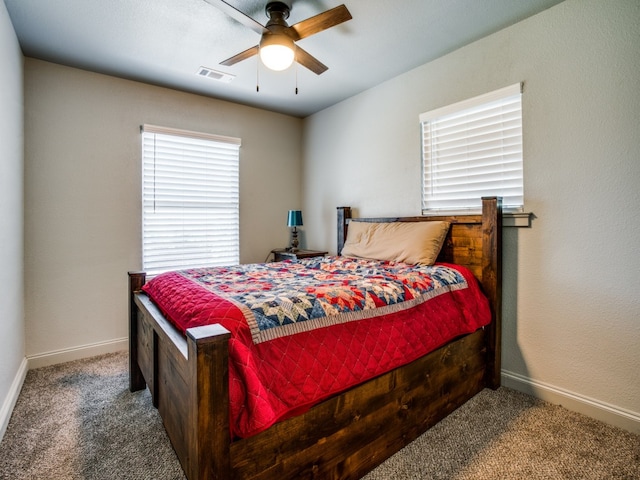 bedroom with dark colored carpet and ceiling fan