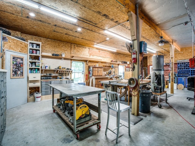 interior space featuring concrete flooring and a workshop area