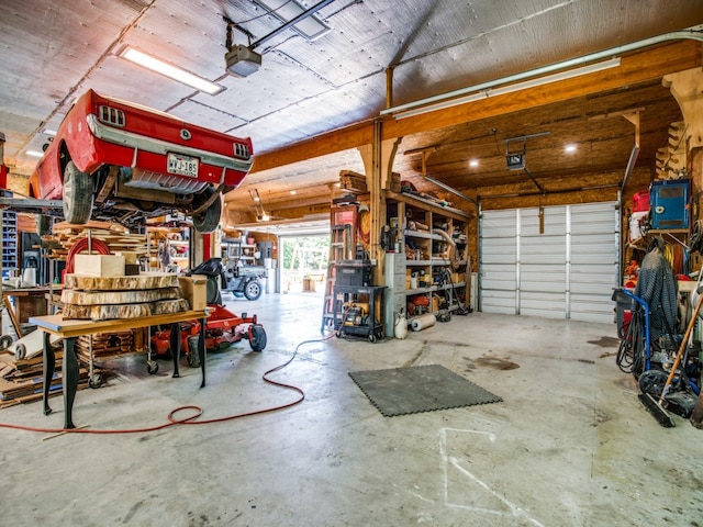 garage with a workshop area and a garage door opener