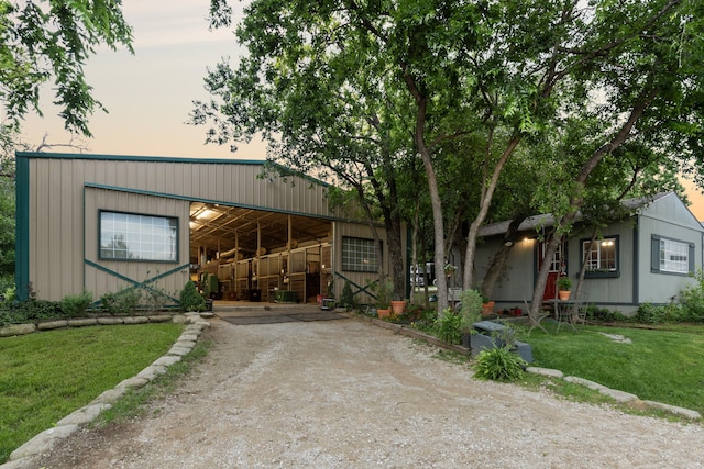 view of front of home featuring a yard and an outdoor structure