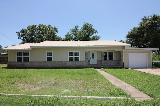 ranch-style home featuring a garage and a front lawn