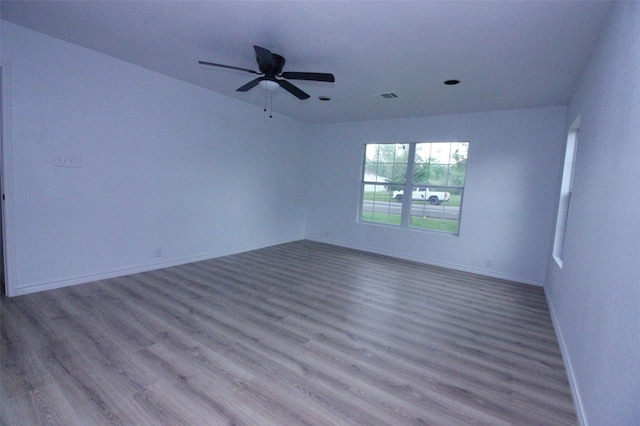 unfurnished room with ceiling fan and hardwood / wood-style flooring