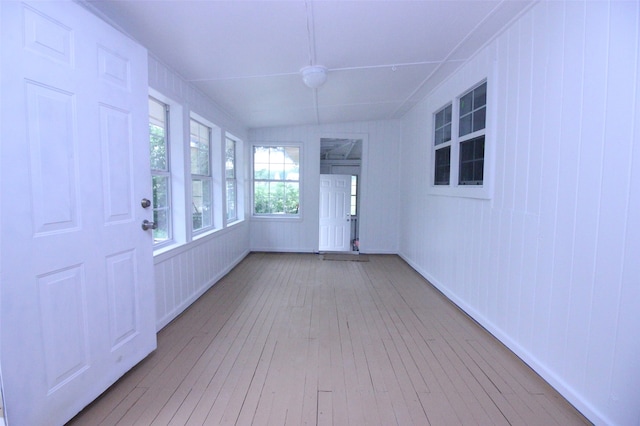 unfurnished sunroom with lofted ceiling