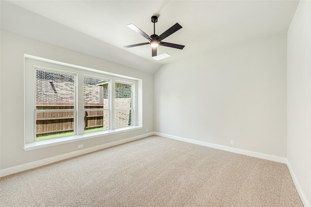 unfurnished room featuring ceiling fan, lofted ceiling, and carpet flooring