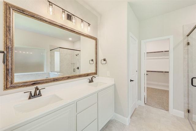 bathroom featuring vanity, tile patterned floors, and a shower with shower door