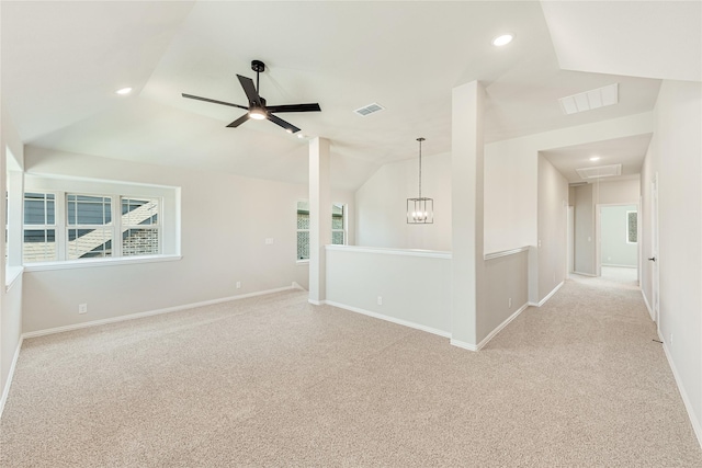 carpeted empty room featuring ceiling fan and vaulted ceiling