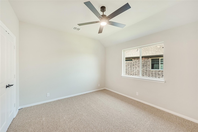 carpeted empty room featuring ceiling fan and lofted ceiling