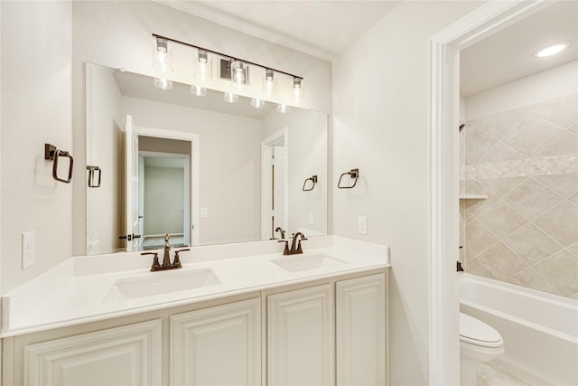 full bathroom featuring toilet, tiled shower / bath, and vanity