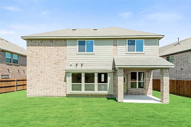 back of property with a patio and a lawn