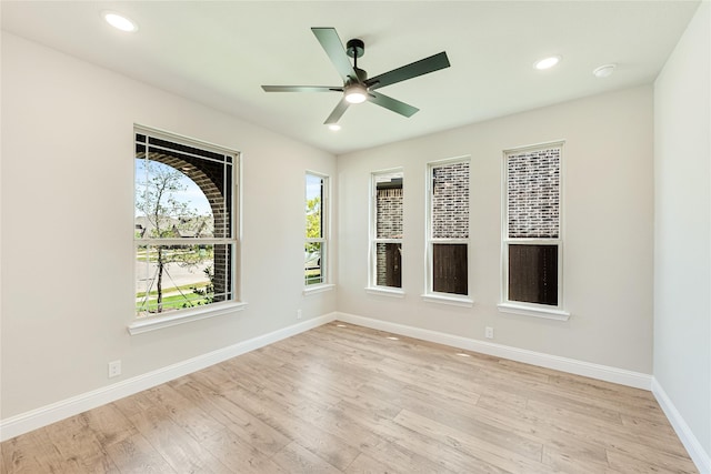 empty room with ceiling fan, light hardwood / wood-style floors, and plenty of natural light