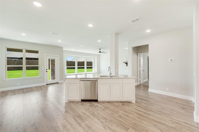 kitchen featuring stainless steel dishwasher, light hardwood / wood-style floors, white cabinetry, ceiling fan, and sink